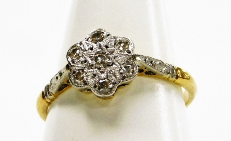 An 18ct gold and diamond seven stone flower head ring, size K, 2.2g.