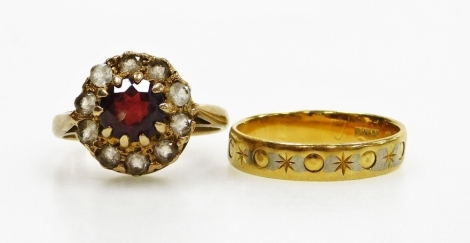 A garnet ring, in a surround of white sapphires, in a yellow metal shank, size J½, 3.1g, together with an 18ct gold wedding band, size K½, 2.6g.