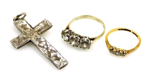 An 18ct gold platinum and diamond three stone ring, size K, 1.8g, together with a silver and paste set three stone ring, and a silver cross with engraved decoration.