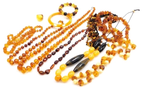 Polished and rough hue and amber bead necklaces, together with a bangle and bracelet. (a quantity)