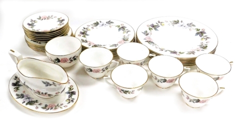 A Royal Worcester porcelain part dinner and tea service decorated in the June Garland pattern, comprising sauce boat on stand, six dinner, dessert and side plates, cream jug, six teacups and saucers.