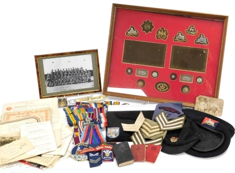 Militaria and sundry ephemera, relating to the Hopper family of Lincolnshire, including cap badges, a Royal Lifesaving Society bronze medal, named to HS Hopper, Lincolnshire Regiment enamel badges, football badge, medal ribbons, photographs, caps, school 