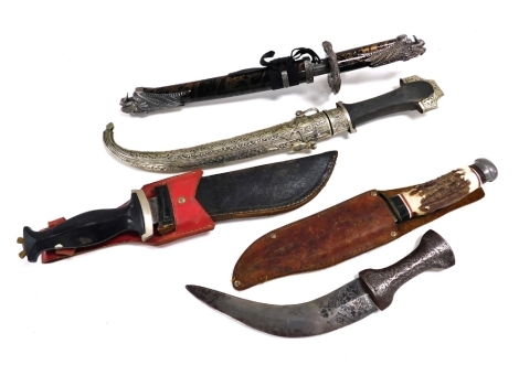 A Persian Khanjar dagger, with an engraved handle and partially engraved steel blade, a Wenoka knife, Whitby Buccaneer type knife, and two further knives. (5)