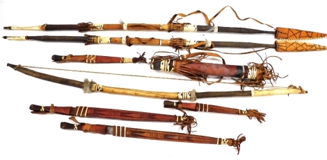 A group of Native American tribal weapons, comprising pair of spears, a bow, four short handled knives, and a quiver. (8)