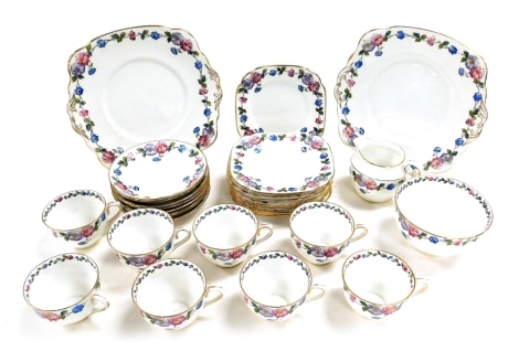 An early 20thC Standard China tea service, decorated with flowers, printed mark, comprising pair of bread plates, cream jug, sugar bowl, eight teacups and saucers, and twelve tea plates.