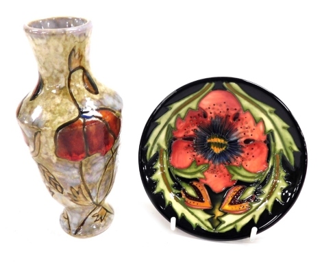 A Moorcroft pottery pin dish decorated in the Pheasants Eye pattern, signed Kerri, dated 2000, painted and impressed marks, 12cm diameter, together with a Black Ryden pottery vase, decorated with poppies and corn against a buff ground, impressed marks and