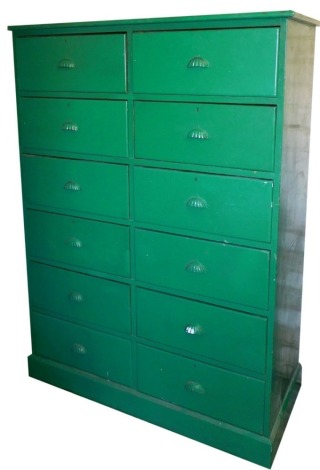 A Victorian green painted pine chest, of twelve drawers, with metal cup handles, raised on a plinth base, 157cm high, 115cm wide, 52cm deep.