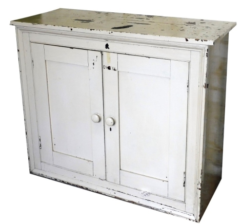 A Victorian white painted pine cupboard, with two doors, 91cm high, 107cm, 44cm deep.