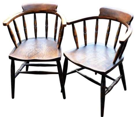 A pair of Victorian beech and elm Captain's type tub chairs, with solid saddle seats, raised on turned legs united by a double H frame stretcher.