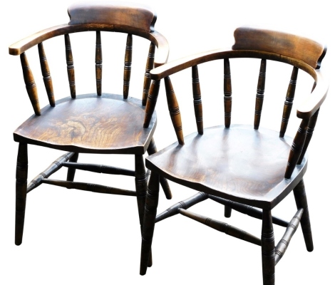 A pair of Victorian beech and elm Captain's type tub chairs, with solid saddle seats, raised on turned legs united by a double H frame stretcher.