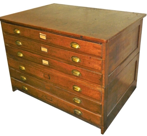 An early 20thC oak plan chest, of six long drawers, raised on a plinth base, 87cm high, 120cm wide, 85cm deep.