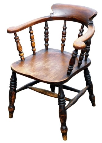 A Victorian beech and oak Captain's chair, raised on turned legs united by a double H frame stretcher.