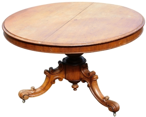 A Victorian mahogany tilt top circular breakfast table, raised on a turned column, over three carved cabriole legs, on brass castors, 77cm high, 119cm wide.