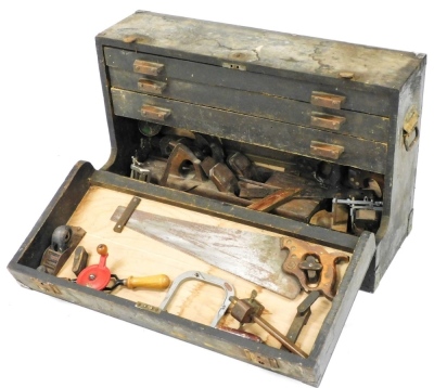 A carpenter's tool chest, with a drop down front opening to reveal three drawers, and contents of moulding planes and other tools, 81cm wide.