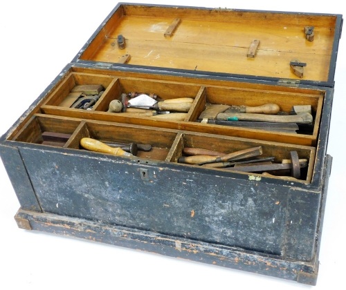 A stained wooden carpenter's tool chest, containing an assortment of tools in a double length tray top, based on castors, 52cm wide.