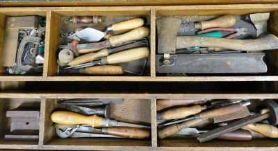 A stained wooden carpenter's tool chest, containing an assortment of tools in a double length tray top, based on castors, 52cm wide. - 3