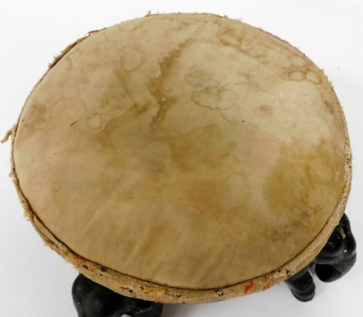 A late 19thC Anglo-Indian ebony circular footstool, raised on four carved elephant supports, 37cm wide. - 2