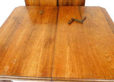 A Victorian mahogany wind out dining table, with two additional leaves, raised on turned and fluted legs, brass capped on castors, 22cm high, 140cm wide, 238cm extended, 121cm deep. - 2