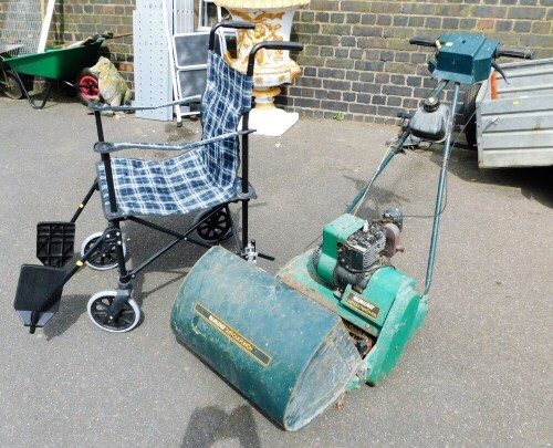 A Qualcast Suffolk Punch 43s lawn mower, and a folding lightweight wheelchair.