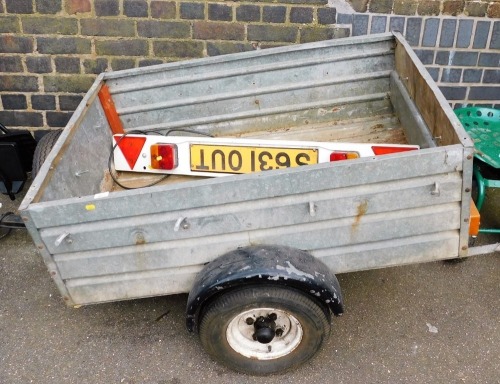 A Honeyfield trailer, 62cm high, 124cm wide, 91cm deep, with spare tyre and trailer lighting board.