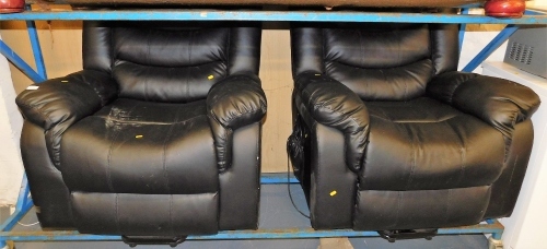 Two black leather electric reclining armchairs.