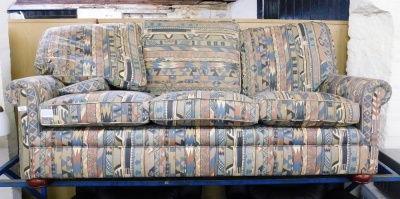 A three seater sofa, with striped pattern fabric. The upholstery in this lot does not comply with the 1988 (Fire & Fire Furnishing) Regulations, unless sold to a known exporter or upholsterer it will be cut from the frame before leaving the premises.