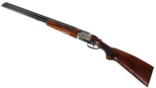 An over and under 12 bore shotgun, with ejector, by Simson Suhl (DR), engraved with a gun dog and hare and scrolling ornamentation, barrels 71cm NB. A current valid Registered Firearms Dealer Certificate will be required to view and bid for this lot. Fo