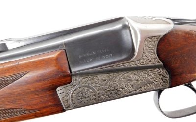 An over and under 12 bore shotgun, with ejector, by Simson Suhl (DR), engraved with a gun dog and hare and scrolling ornamentation, barrels 71cm NB. A current valid Registered Firearms Dealer Certificate will be required to view and bid for this lot. Fo - 3