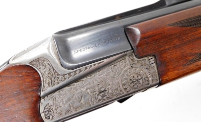 An over and under 12 bore shotgun, with ejector, by Simson Suhl (DR), engraved with a gun dog and hare and scrolling ornamentation, barrels 71cm NB. A current valid Registered Firearms Dealer Certificate will be required to view and bid for this lot. Fo - 4