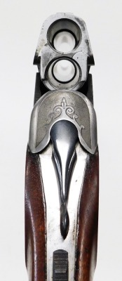 An over and under 12 bore shotgun, with ejector, by Simson Suhl (DR), engraved with a gun dog and hare and scrolling ornamentation, barrels 71cm NB. A current valid Registered Firearms Dealer Certificate will be required to view and bid for this lot. Fo - 6