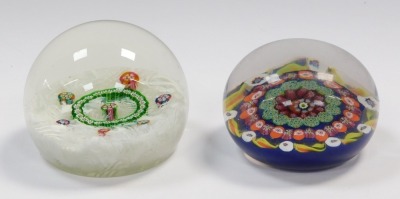 A 20thC millefiori and scrambled latticino paperweight, 8cm diameter, and a millefiori and candy cane paperweight, dark blue ground, 7.5cm diameter. (2) - 3