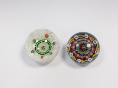 A 20thC millefiori and scrambled latticino paperweight, 8cm diameter, and a millefiori and candy cane paperweight, dark blue ground, 7.5cm diameter. (2) - 4