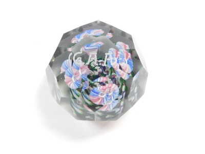 An early 20thC faceted glass paperweight, decorated internally with four glass stemmed flowers, on a green base, beneath initials 'G. A. A.', 9.5cm diameter. - 4