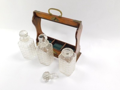 A 19thC oak tantalus, the oak case fitted with three cut glass decanters, and brass cap ends and swing handle support, with key, 35cm high, 34cm wide, 11cm deep. - 4