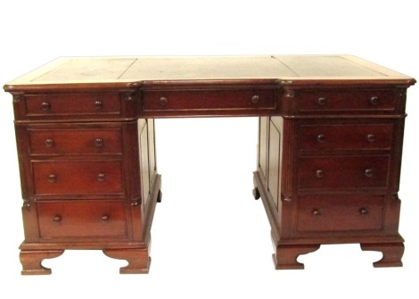 A Victorian style mahogany twin pedestal desk, the break front top with gilt tooled black leather inset, over three drawers, two pedestals each with three graduated drawers, raised on ogee bracket feet, 75.5cm high, 150cm wide, 93cm deep.