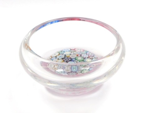 A Peter McDougall millefiori glass dish, with various close canes, bears paper label, 10.5cm diameter.