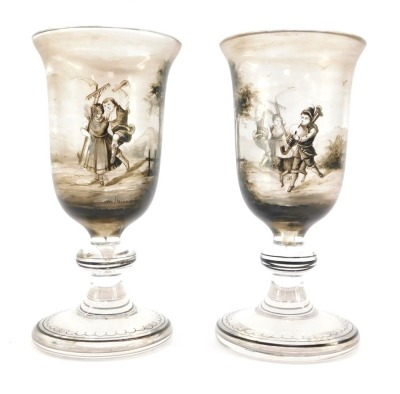 A pair of early 19thC Continental wine glasses, the trumpet shaped bowl painted in shades of grey with pastoral figures in a landscape, on a banded and teardrop included single knop stem, raised on an outswept conical foot, 16cm high.