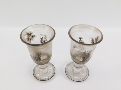 A pair of early 19thC Continental wine glasses, the trumpet shaped bowl painted in shades of grey with pastoral figures in a landscape, on a banded and teardrop included single knop stem, raised on an outswept conical foot, 16cm high. - 4