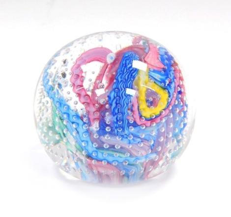 A vintage millefiori swirl paperweight, with graduated bands of air bubbles, 8cm diameter.