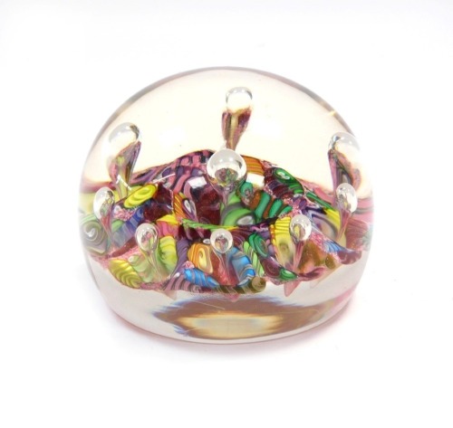 A Paul Ysart Magnum harlequin glass paperweight, circa 1970, with scrambled polychrome canes and nine air bubbles, 7cm diameter.