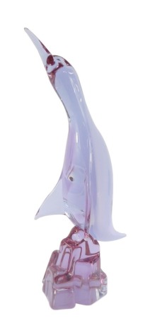 A Murano amethyst glass figure of a Cormorant, modelled perched on a rock, bears indistinct signature, 38.5cm high.