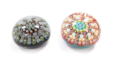 A Perthshire concentric millefiori and spiral twist paperweight, turquoise ground, central P cane, 6cm diameter, and an earlier similar paperweight, maker unknown, 6cm diameter. (2)