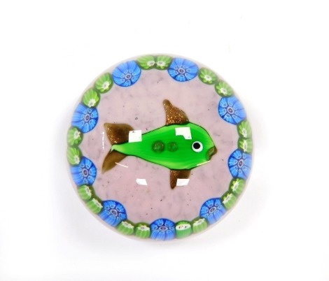 A Paul Ysart style glass paperweight, decorated with a fish, within repeating blue and green millefiori against a mottled pink ground, PY cane with the Y slightly dropped, 6.5cm diameter.