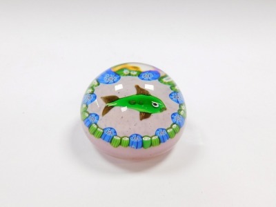 A Paul Ysart style glass paperweight, decorated with a fish, within repeating blue and green millefiori against a mottled pink ground, PY cane with the Y slightly dropped, 6.5cm diameter. - 2