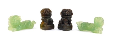 A pair of Chinese hard stone seals, modelled as Dogs of Fo, 93mm high, together with a pair of jadeite figures of recumbent children, 5cm wide. (4)