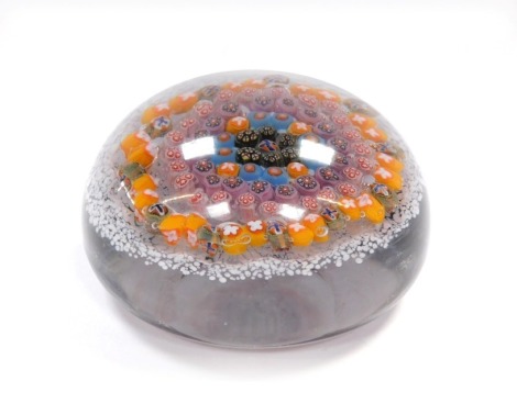 A concentric millefiori paperweight, possibly Vasart, set against a white mottled ground, 9.5cm diameter.