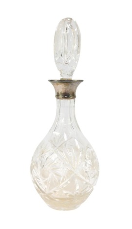 A cut glass decanter, and stopper, with silver collar, London 1969, 33cm high.