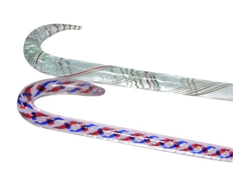 A Nailsea glass walking stick, with red, blue and white opaque twist decoration, 96cm high, and a further glass walking stick, with spiral glass decoration, 120cm high. (2)