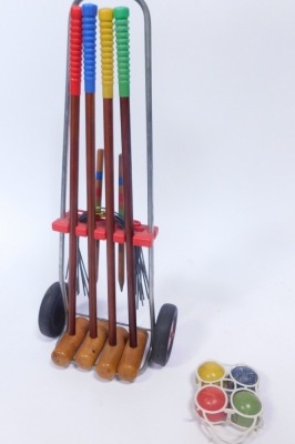 A croquet set, on wheelie trolley, with four mallets, stakes and set of four balls. (AF)