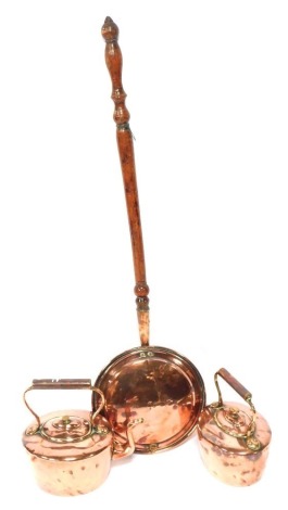 Two Victorian copper kettles and a copper warming pan. (3)